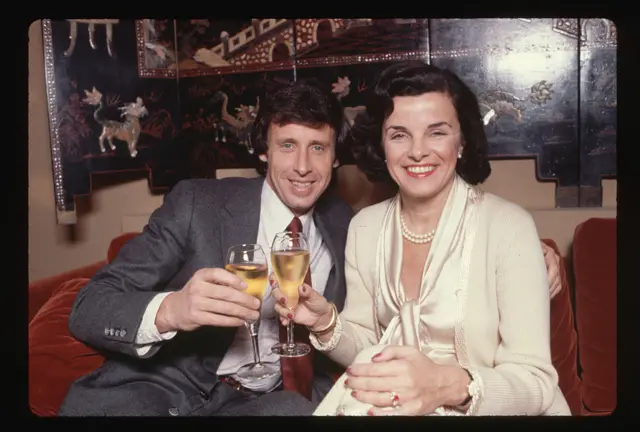 San Francisco Mayor Dianne Feinstein and her fiance Richard Blum, an investment banker, celebrate their wedding announcement with champagne.