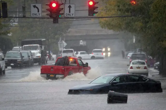 A car sits in rising flood waters in Westchester County, a New York City suburb