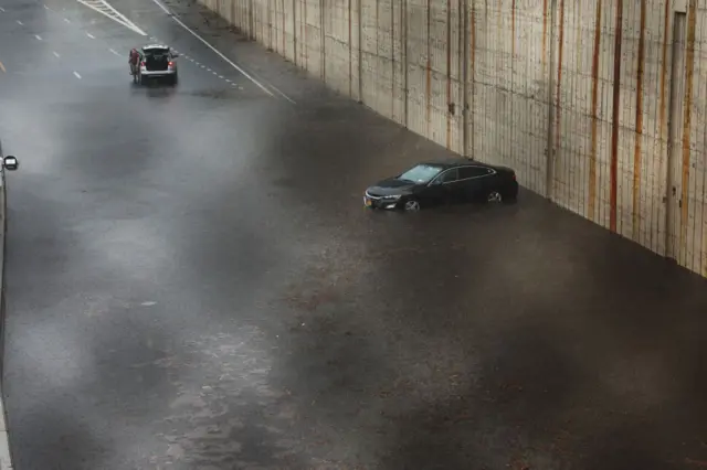 A vehicle sits submerged after it got stuck on the Prospect Expressway