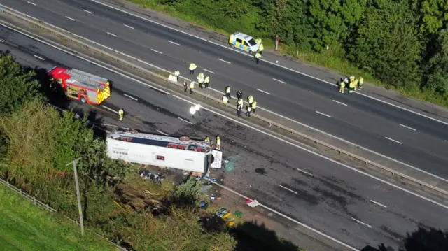 Emergency services at the scene of a coach crash on the M53 motorway