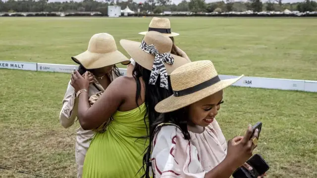 Spectators chat before a polo match in Kenya on Sunday.