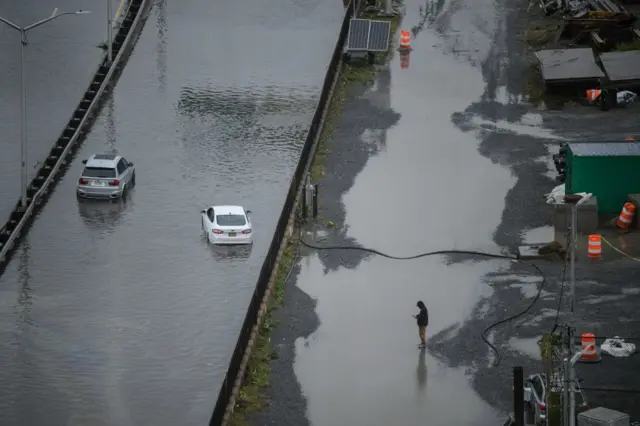 A general view shows cars stranded in floodwater on the FDR highway in Manhattan, New York on September 29, 2023