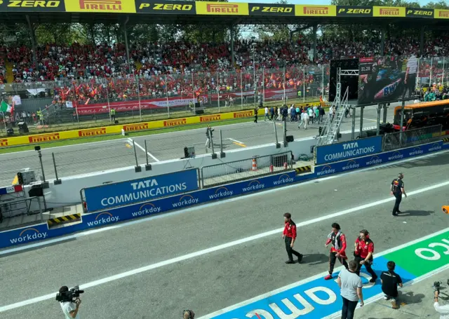 Carlos Sainz walks back to the garage