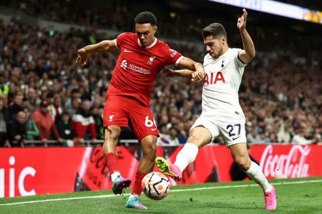 Trent Alexander-Arnold fights for the ball with Manor Solomon