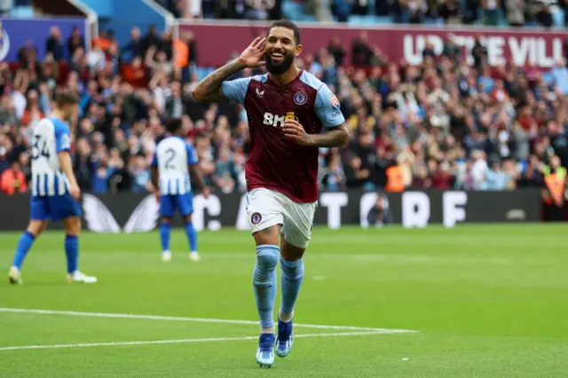 Douglas Luiz celebrates