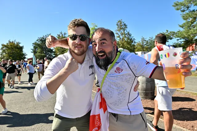 Supporters wearing Georgian and Fijian support jerseys pose