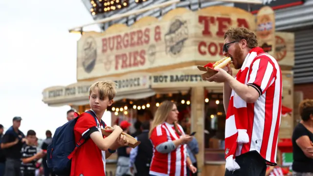 Fans enjoy pre-match food outside St Mary's Stadium in Southampton.