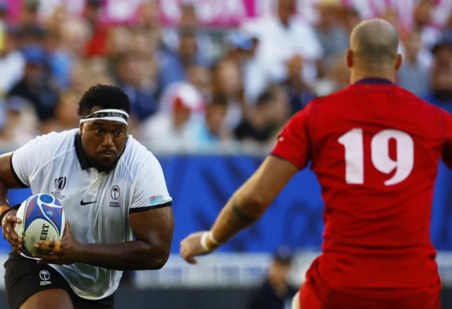 Fiji's Eroni Mawi runs with the ball