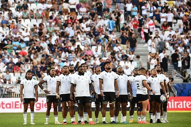 Fiji players look on before the start of the second-half