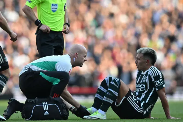 Lisandro Martinez is attended to by a club physio.