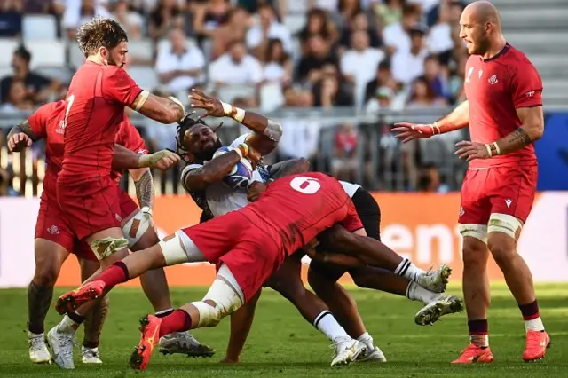 Fiji's centre Waisea Nayacalevu is tackled by Georgia's flanker Mikheil Gachechiladze