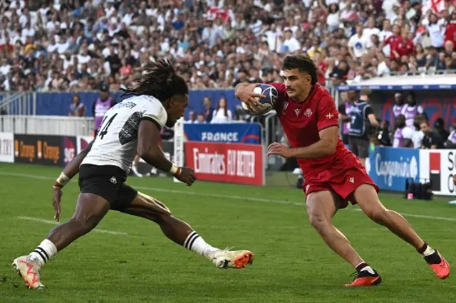 Georgia's wing Davit Niniashvili runs with the ball
