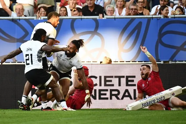 Fiji's centre Waisea Nayacalevu celebrates with teammates