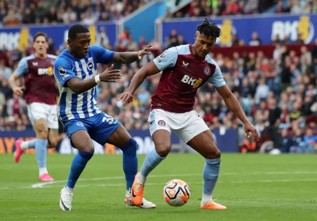 Ollie Watkins  on the ball whilst under pressure from Pervis Estupinan