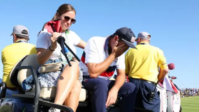 Scottie Scheffler being consoled by his wife