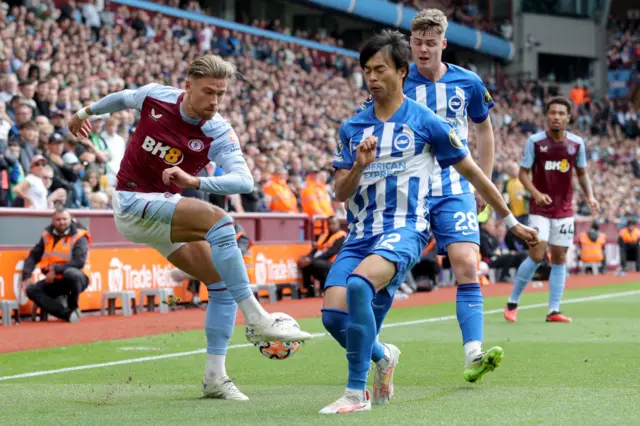 Matty Cash challenges for the ball with Kaoru Mitoma