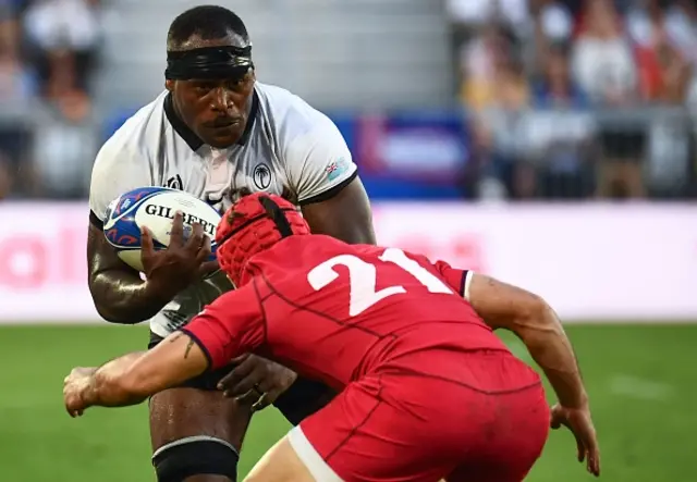 Fiji's flanker Levani Botia is tackled by Georgia's scrum-half Gela Aprasidze