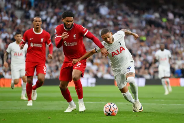 Joe Gomez is challenged by Richarlison