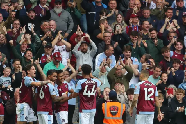 Aston Villa players celebrate with fans