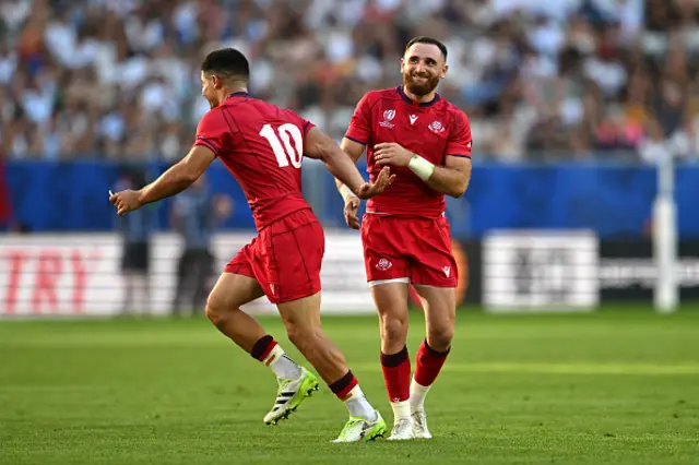 Vasil Lobzhanidze of Georgia reacts as they speak with Luka Matkava