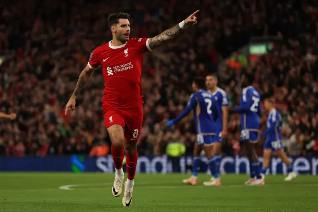 Szoboszlai points to the crowd after scoring versus Leicester City.