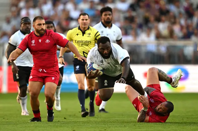 Luke Tagi of Fiji is tackled by Beka Gigashvili of Georgia