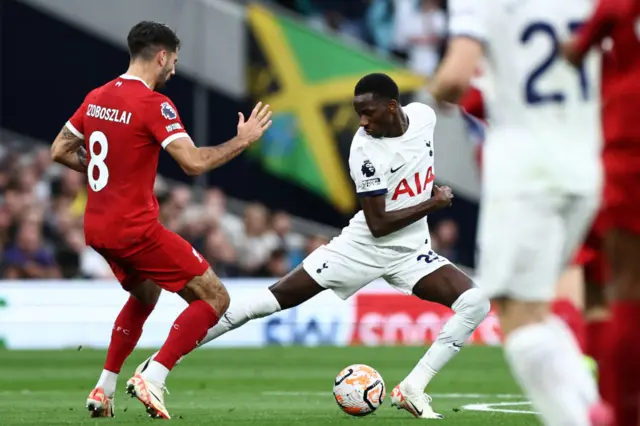 Dominik Szoboszlai fights for the ball with  Pape Matar Sarr