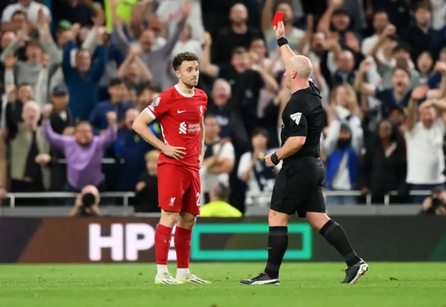 Simon Hooper shows a red card to Diogo Jota