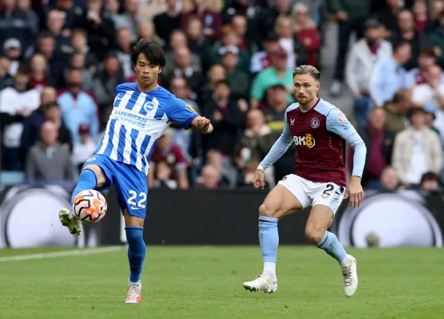 Kaoru Mitoma and Matty Cash battle for the ball