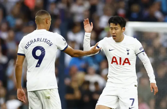 Son Heung-min celebrates scoring their first goal with Richarlison