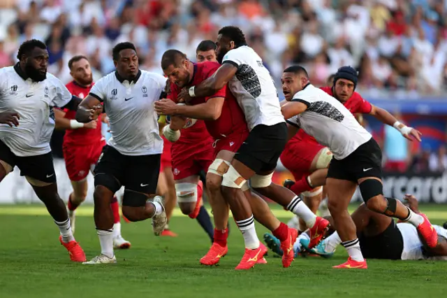 Konstantin Mikautadze of Georgia is tackled by Samuel Matavesi and Lekima Tagitagivalu