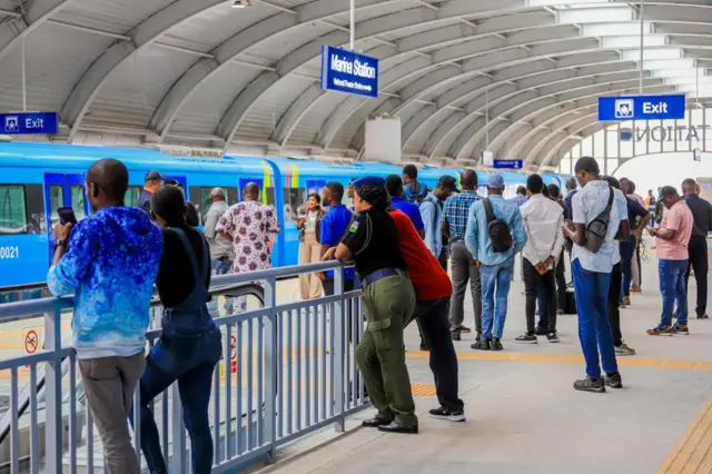 Commuters standing at a Lagos train station