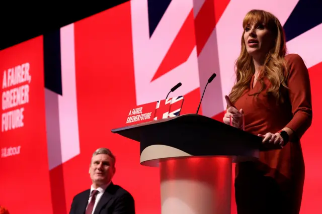 Angela Rayner speaks as Keir Starmer in the background