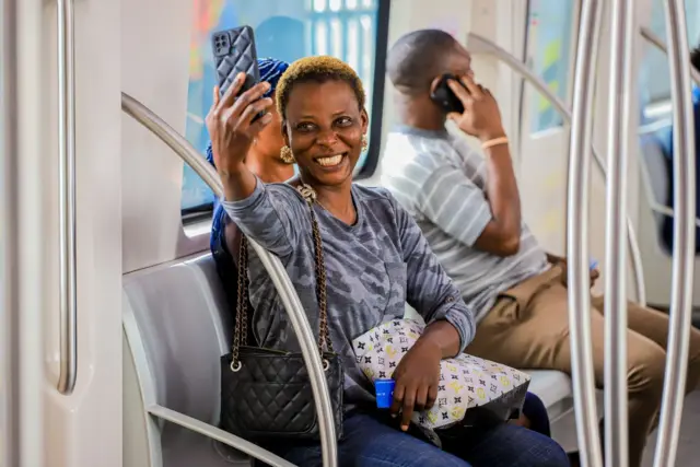 A woman takes a selfie inside a train in Lagos