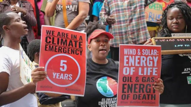 Civil society groups from across Africa hold placards during a peaceful protest against the continent's inaugural climate summit, marching against the use of fossil fuels in the region while demanding that governments and industries transition to renewable energy in Nairobi, Kenya September 4, 2023