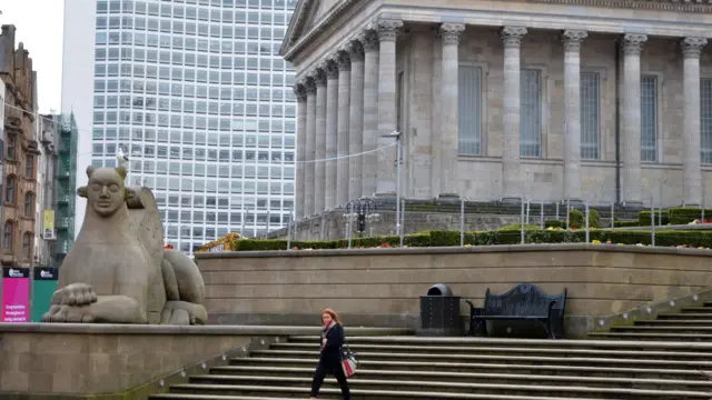 A woman walks through central Birmingham