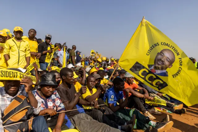 A Citizens Coalition for Change (CCC) member holds a flag during the party's final campaign rally on August 21, 2023 in Harare,