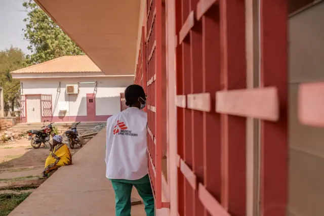 A Doctors Without Borders (MSF) nurse arrives at a ward where patients with an advanced stage of Acquired Immunodeficiency Syndrome (AIDS) are treated at the community hospital in Bangui,on January 27, 2022.