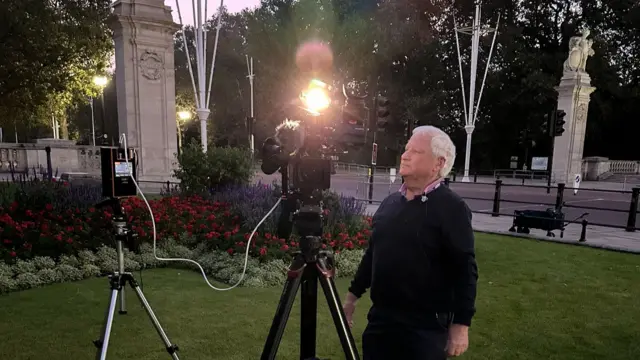 Cameraman Bernard alongside Carol Kirkwood at St James's park