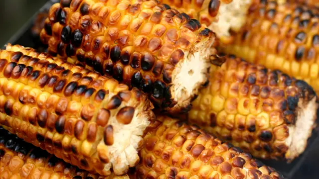 Sweet corn cooking on a barbecue