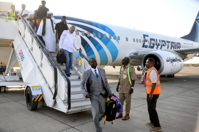 Passengers disembark off an EgyptAir Boeing 737 aircraft upon landing for the first time at Port Sudan International Airport on September 5, 2023 upon the inauguration of a new international flight route between Cairo and Port Sudan.