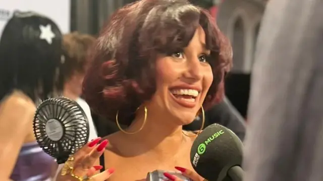 Raye speaks on the red carpet at the Mercury Awards