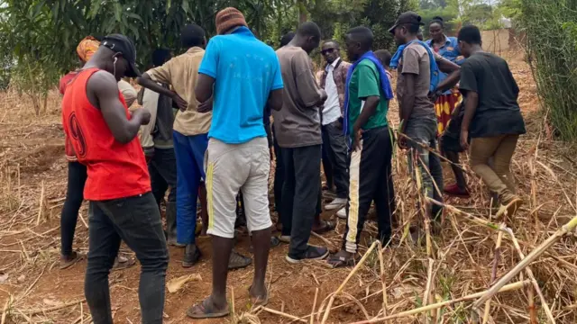 People outside the suspected killer's rented accommodation in Kigali, Rwanda