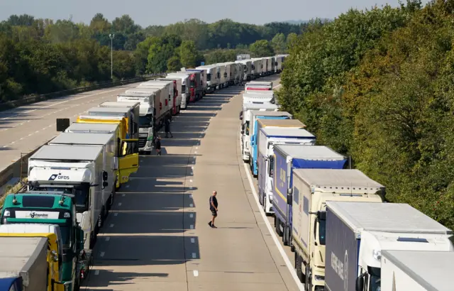 Some drivers seem to be bored waiting and stretching their legs out of their lorries