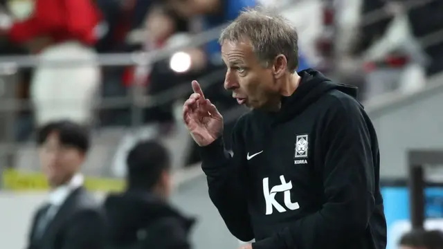 Jurgen Klinsmann gives instructions to his South Korea players