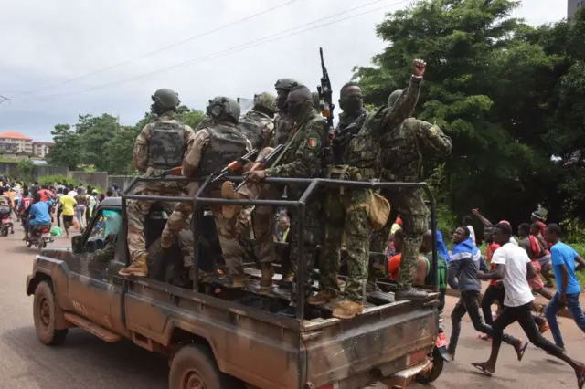 People celebrate in the streets with members of Guinea's armed forces after a coup in Conakry - September 2021