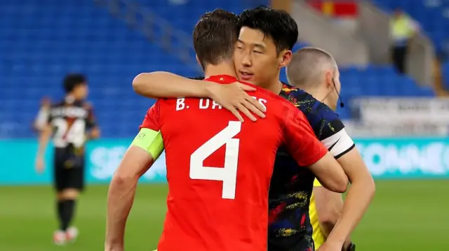 Ben Davies hugs Son Heung-min