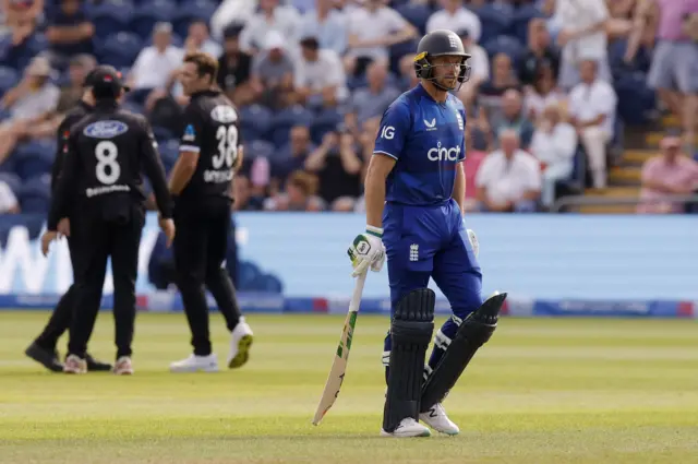 England's Jos Buttler leaves the field after losing his wicket