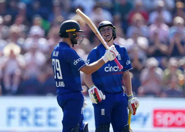 Dawid Malan celebrates his half-century as Harry Brook looks on