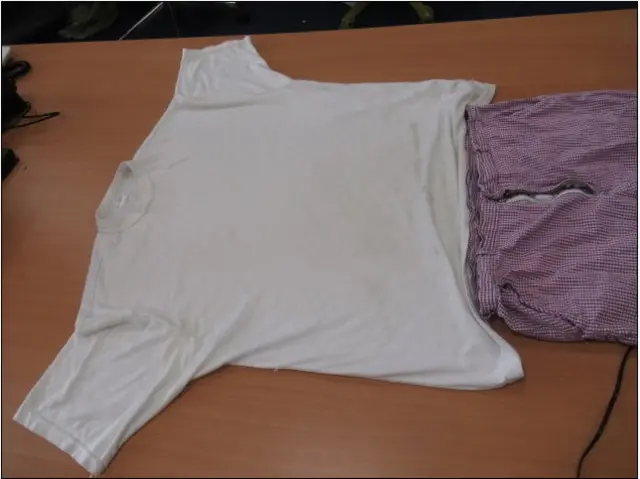 White T-shirt laid out on table